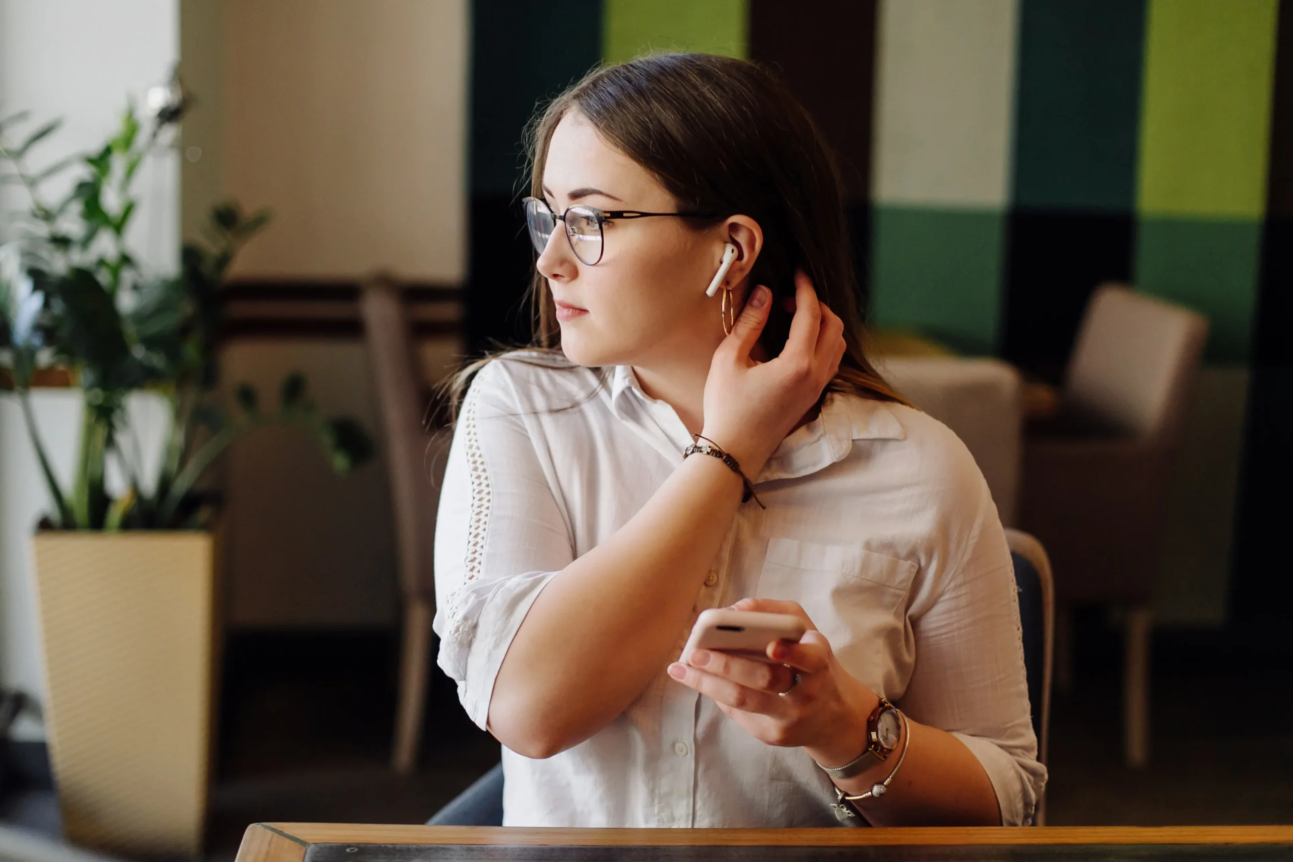 beautiful woman working her laptop phone stylish urban restaurant scaled